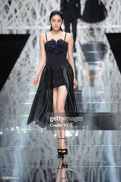 Model showcases designs on the runway at GIOIA PAN Collection show during the fourth day of the Mercedes-Benz China Fashion Week Spring/Summer 2015...