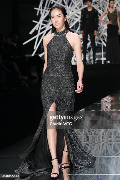 Model showcases designs on the runway at GIOIA PAN Collection show during the fourth day of the Mercedes-Benz China Fashion Week Spring/Summer 2015...