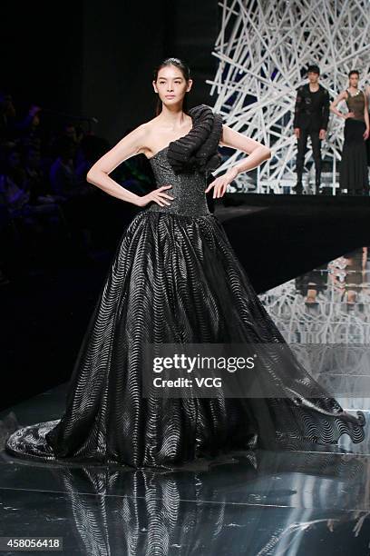 Model showcases designs on the runway at GIOIA PAN Collection show during the fourth day of the Mercedes-Benz China Fashion Week Spring/Summer 2015...