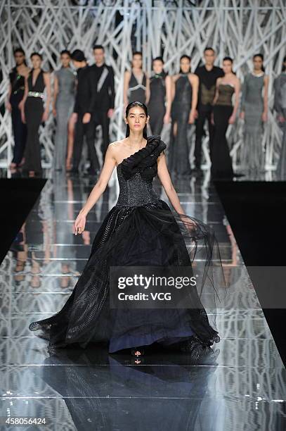 Model showcases designs on the runway at GIOIA PAN Collection show during the fourth day of the Mercedes-Benz China Fashion Week Spring/Summer 2015...