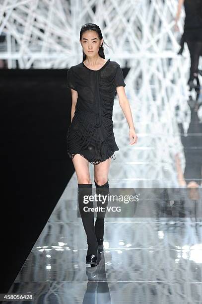Model showcases designs on the runway at GIOIA PAN Collection show during the fourth day of the Mercedes-Benz China Fashion Week Spring/Summer 2015...