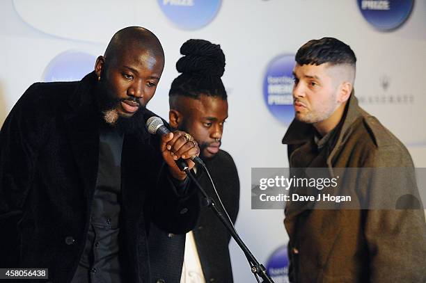 Winners of the Barclaycard Mercury Prize Alloysious Massaquoi, 'G' Hastings and Kayus Bankole of Young Fathers pose in the winners room at the...