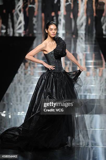 Model showcases designs on the runway at GIOIA PAN Collection show during the fourth day of the Mercedes-Benz China Fashion Week Spring/Summer 2015...