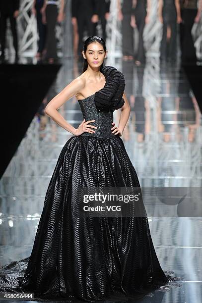 Model showcases designs on the runway at GIOIA PAN Collection show during the fourth day of the Mercedes-Benz China Fashion Week Spring/Summer 2015...