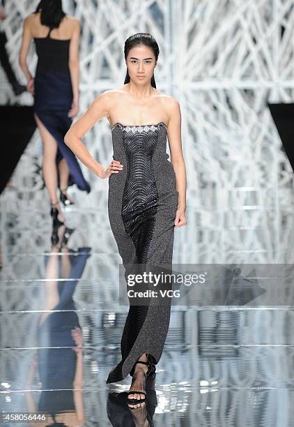 Model showcases designs on the runway at GIOIA PAN Collection show during the fourth day of the Mercedes-Benz China Fashion Week Spring/Summer 2015...