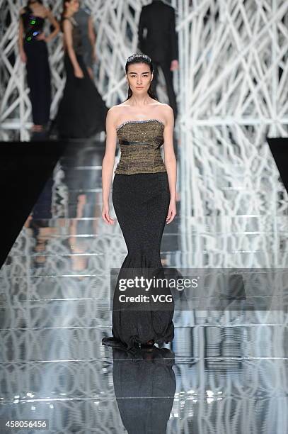 Model showcases designs on the runway at GIOIA PAN Collection show during the fourth day of the Mercedes-Benz China Fashion Week Spring/Summer 2015...