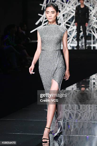 Model showcases designs on the runway at GIOIA PAN Collection show during the fourth day of the Mercedes-Benz China Fashion Week Spring/Summer 2015...