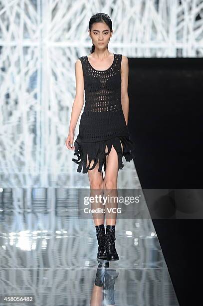 Model showcases designs on the runway at GIOIA PAN Collection show during the fourth day of the Mercedes-Benz China Fashion Week Spring/Summer 2015...