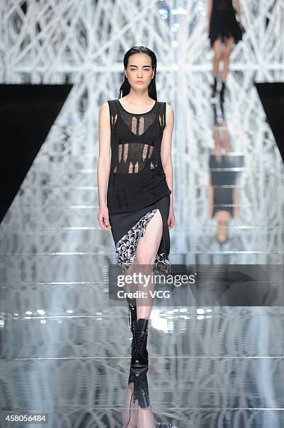 Model showcases designs on the runway at GIOIA PAN Collection show during the fourth day of the Mercedes-Benz China Fashion Week Spring/Summer 2015...