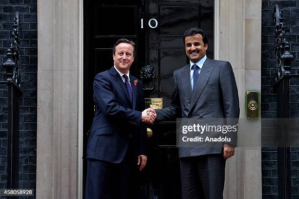 British Prime Minister David Cameron greets the Emir of Qatar; Sheikh Tamim bin Hamad Al Thani at No10 Downing Street on October 29, 2014 in London,...