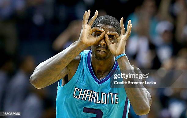 Marvin Williams of the Charlotte Hornets reacts after making a basket against the Milwaukee Bucks during their game at Time Warner Cable Arena on...