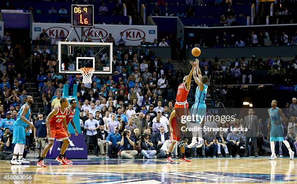 Kemba Walker of the Charlotte Hornets shoots the game winning shot over Brandon Knight of the Milwaukee Bucks during their game at Time Warner Cable...