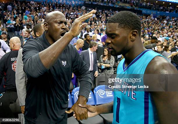 Michael Jordan, owner of the Charlotte Hornets, celebrates with Lance Stephenson of the Charlotte Hornets after defeating the Milwaukee Bucks 108-106...