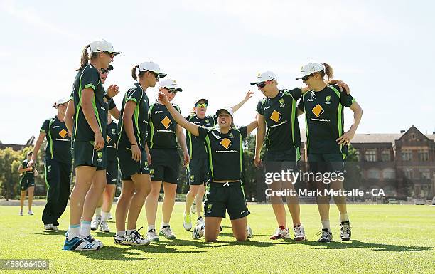 Ellyse Perry leads a team celebration during an Australian Southern Stars training session at Sydney University on October 30, 2014 in Sydney,...