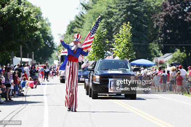 uncle sam tall man marching july 4th independence day parade - parade stock pictures, royalty-free photos & images