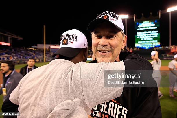 Manager Bruce Bochy of the San Francisco Giants celebrates on the field after defeating the Kansas City Royals 3-2 to win Game Seven of the 2014...