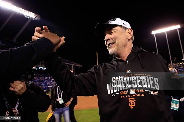 Manager Bruce Bochy of the San Francisco Giants celebrates on the field after defeating the Kansas City Royals 3-2 to win Game Seven of the 2014...