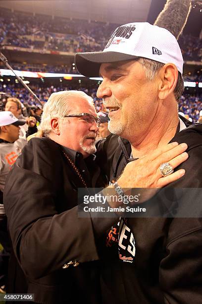 Manager Bruce Bochy of the San Francisco Giants celebrates on the field with general manager Brian Sabean after defeating the Kansas City Royals 3-2...