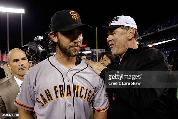 Manager Bruce Bochy of the San Francisco Giants celebrates on the field with Madison Bumgarner after defeating the Kansas City Royals 3-2 to win Game...