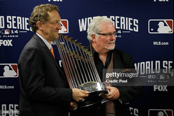 San Francisco Giants general manager Brian Sabean holds The Commissioner's Trophy after defeating the Kansas City Royals 3-2 in Game Seven of the...