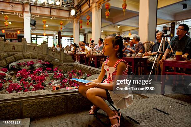 audience enjoying sichuan opera in traditional teahouse - peking opera stock pictures, royalty-free photos & images