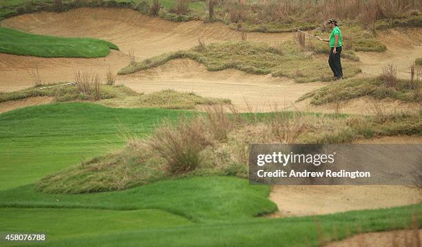 Victor Dubuisson of France prepares to play his third shot on the 14th hole during the first round of the BMW Masters at Lake Malaren Golf Club on...