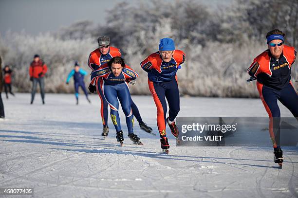 people ice-skating on a lake in the netherlands - ice skate stock pictures, royalty-free photos & images