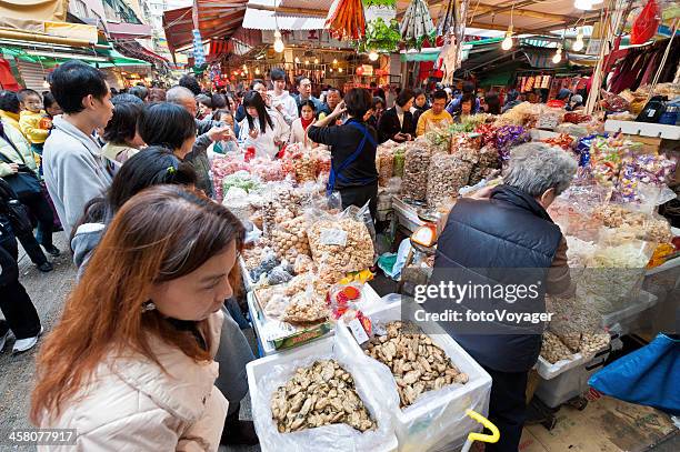 crowded street market stall hong kong china - sheung wan stock pictures, royalty-free photos & images