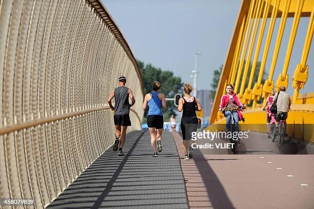 cyclists and exercising runners in utrecht - utrecht stockfoto's en -beelden