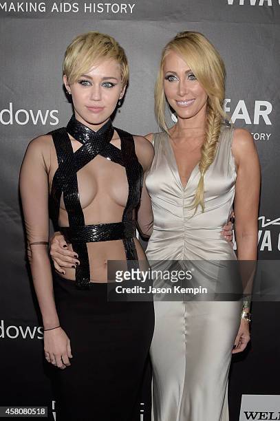 Singer Miley Cyrus and Tish Cyrus attend the 2014 amfAR LA Inspiration Gala at Milk Studios on October 29, 2014 in Hollywood, California.