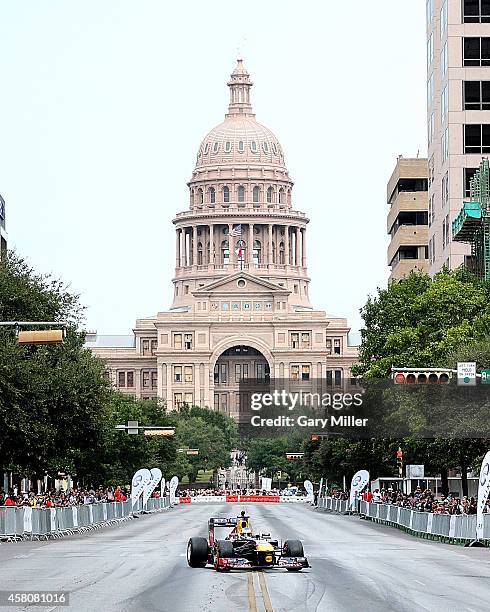 Sebastian Vettel drives his Formula 1 race car in front of the State Capital during the Zero To Infiniti event on October 29, 2014 in Austin, Texas.