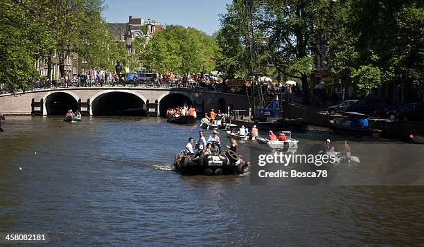 queen's day parade in amsterdam - relfection stock pictures, royalty-free photos & images