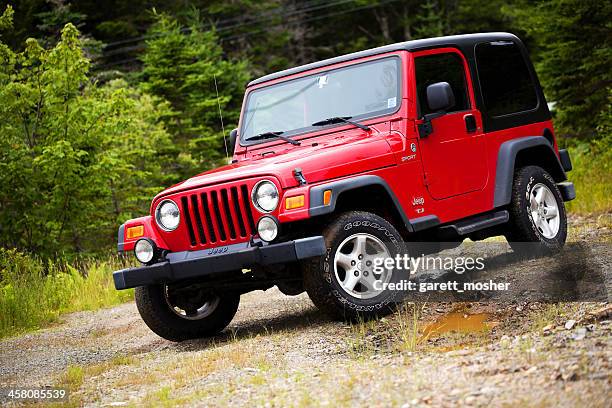 jeep wrangler tj sitting on muddy dirt and gravel trail - jeep wrangler stock pictures, royalty-free photos & images