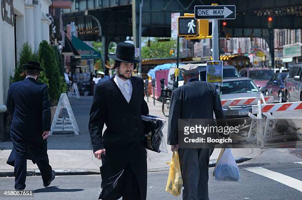 new york city jewish hassidic man crosses the street - orthodox stock pictures, royalty-free photos & images