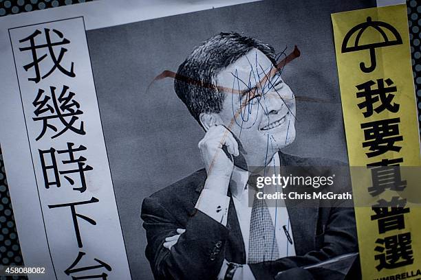 Poster showing Hong Kong's Chief Executive C.Y. Leung is seen on a wall at the Occupy Central protest site in the Admiralty District on October 29,...