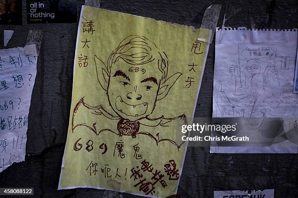 Poster showing Hong Kong's Chief Executive C.Y. Leung is seen on a wall at the Occupy Central protest site in the Admiralty District on October 29,...