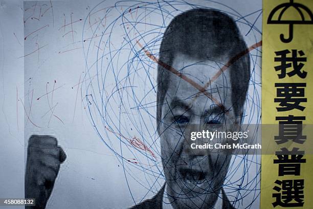 Poster showing Hong Kong's Chief Executive C.Y. Leung is seen on a wall at the Occupy Central protest site in the Admiralty District on October 29,...