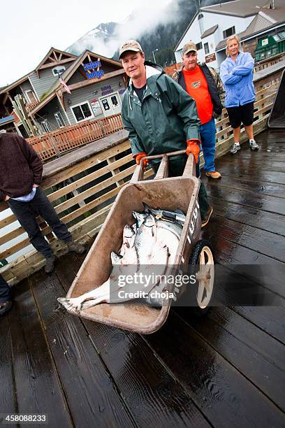 fisherman from seward,alaska usa  with his daily catch. - barrow alaska stock pictures, royalty-free photos & images