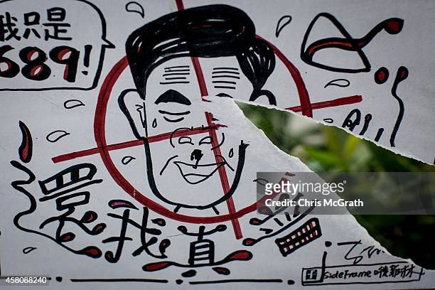 Poster showing Hong Kong's Chief Executive C.Y. Leung is seen on a wall at the Occupy Central protest site in the Admiralty District on October 29,...