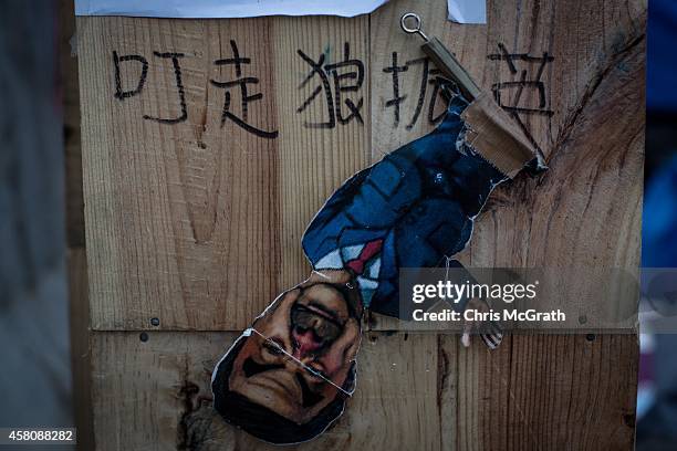 Poster showing Hong Kong's Chief Executive C.Y. Leung is seen on a wall at the Occupy Central protest site in the Admiralty District on October 29,...