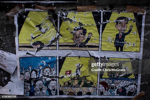 Poster showing Hong Kong's Chief Executive C.Y. Leung is seen on a wall at the Occupy Central protest site in the Admiralty District on October 29,...