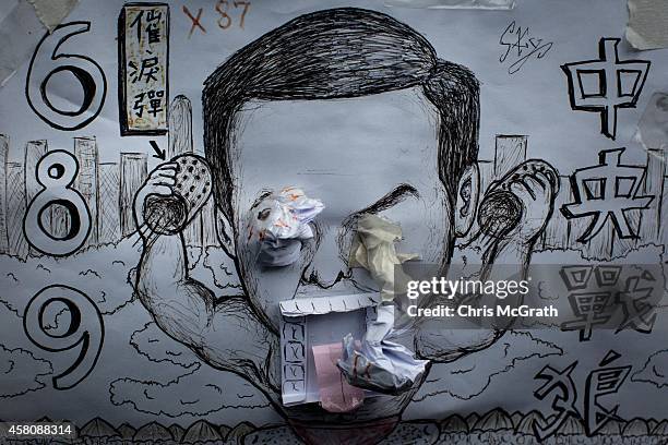 Poster showing Hong Kong's Chief Executive C.Y. Leung is seen on a wall at the Occupy Central protest site in the Admiralty District on October 29,...