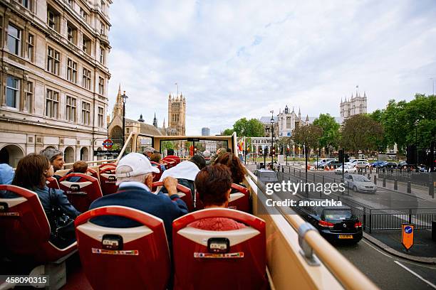 tourists enjoying the ride on a tour bus in london - double decker bus stock pictures, royalty-free photos & images