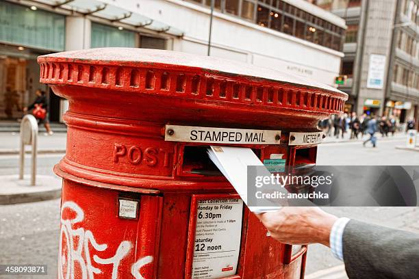 businessman sending mail on one of the london streets - openbare brievenbus stockfoto's en -beelden