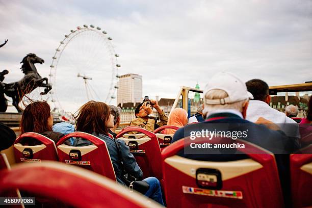 tourists enjoying the ride on a tour bus in london - open top bus stock pictures, royalty-free photos & images