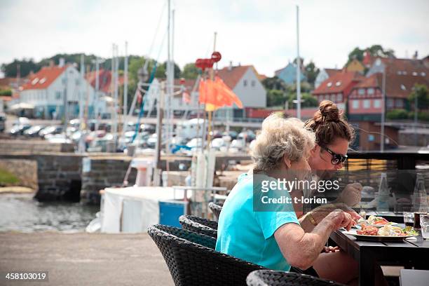 eating fish in svaneke. - bornholm island stock pictures, royalty-free photos & images