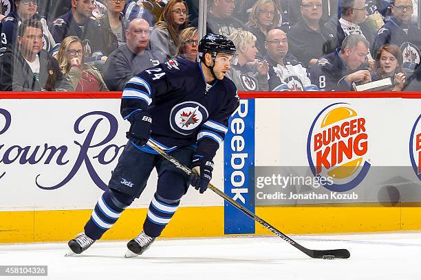 Grant Clitsome of the Winnipeg Jets plays the puck up the ice during first period action against the Tampa Bay Lightning on October 24, 2014 at the...