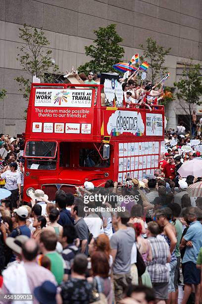 toronto gay pride parade participants on red double-decker bus - toronto pride march stock pictures, royalty-free photos & images