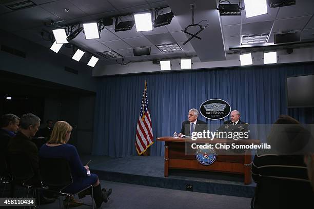 Defense Secretary Chuck Hagel and Chairman of the Joint Chiefs of Staff Gen. Martin Dempsey hold a news conference at the Pentagon October 30, 2014...