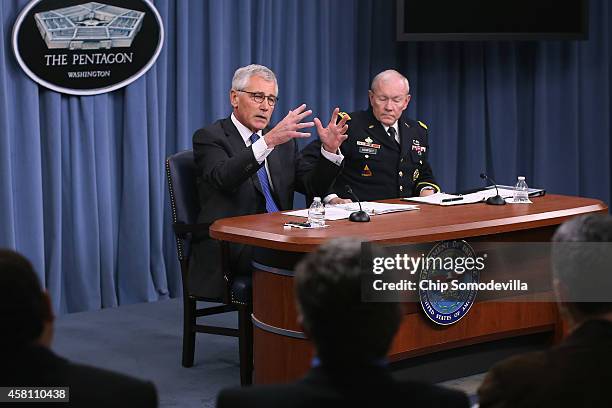 Defense Secretary Chuck Hagel and Chairman of the Joint Chiefs of Staff Gen. Martin Dempsey hold a news conference at the Pentagon October 30, 2014...